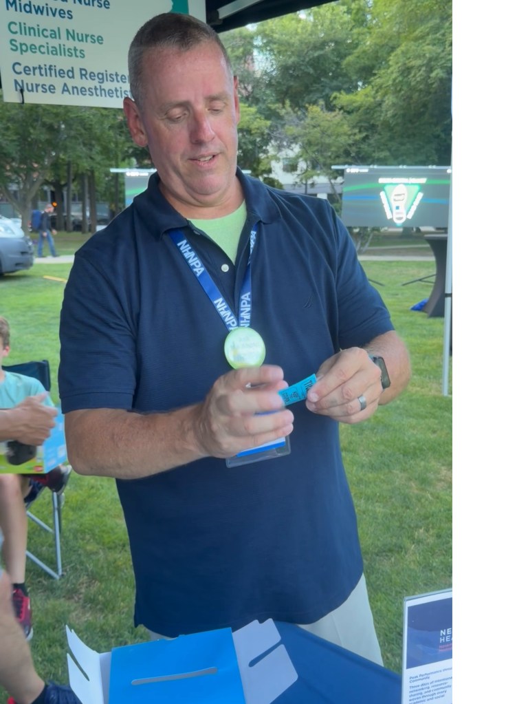 Rick LePage drawing the NHNPA raffle winner at the Elliott Corporate 5K