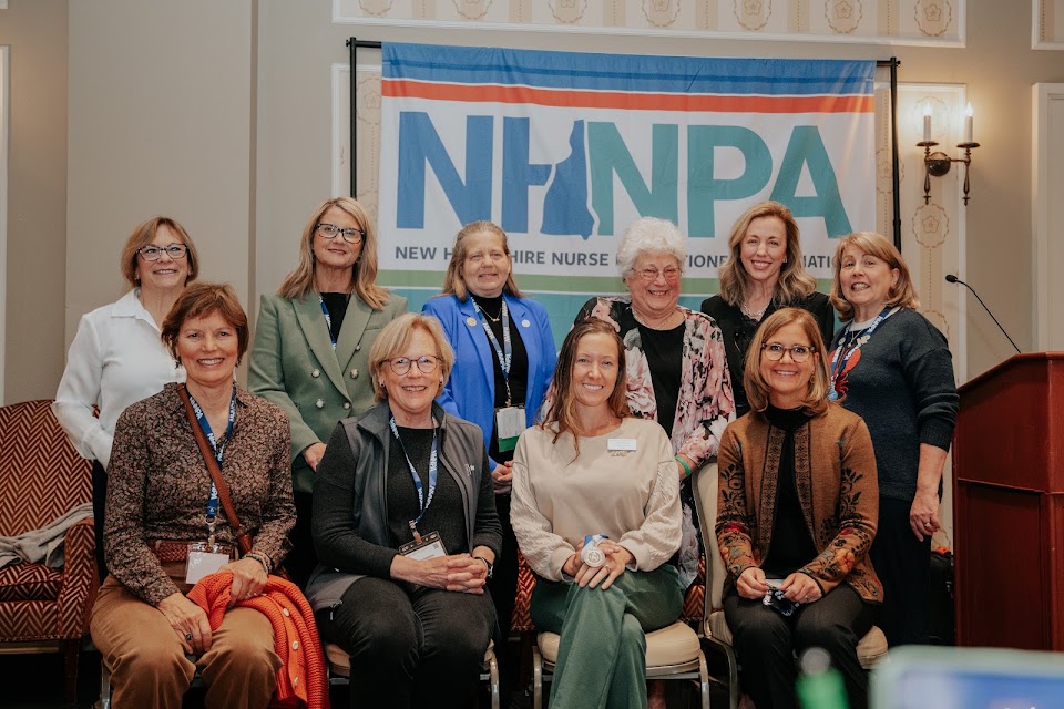 NHNPA members and leaders gathered for a group photo in front of the NHNPA banner at the annual conference