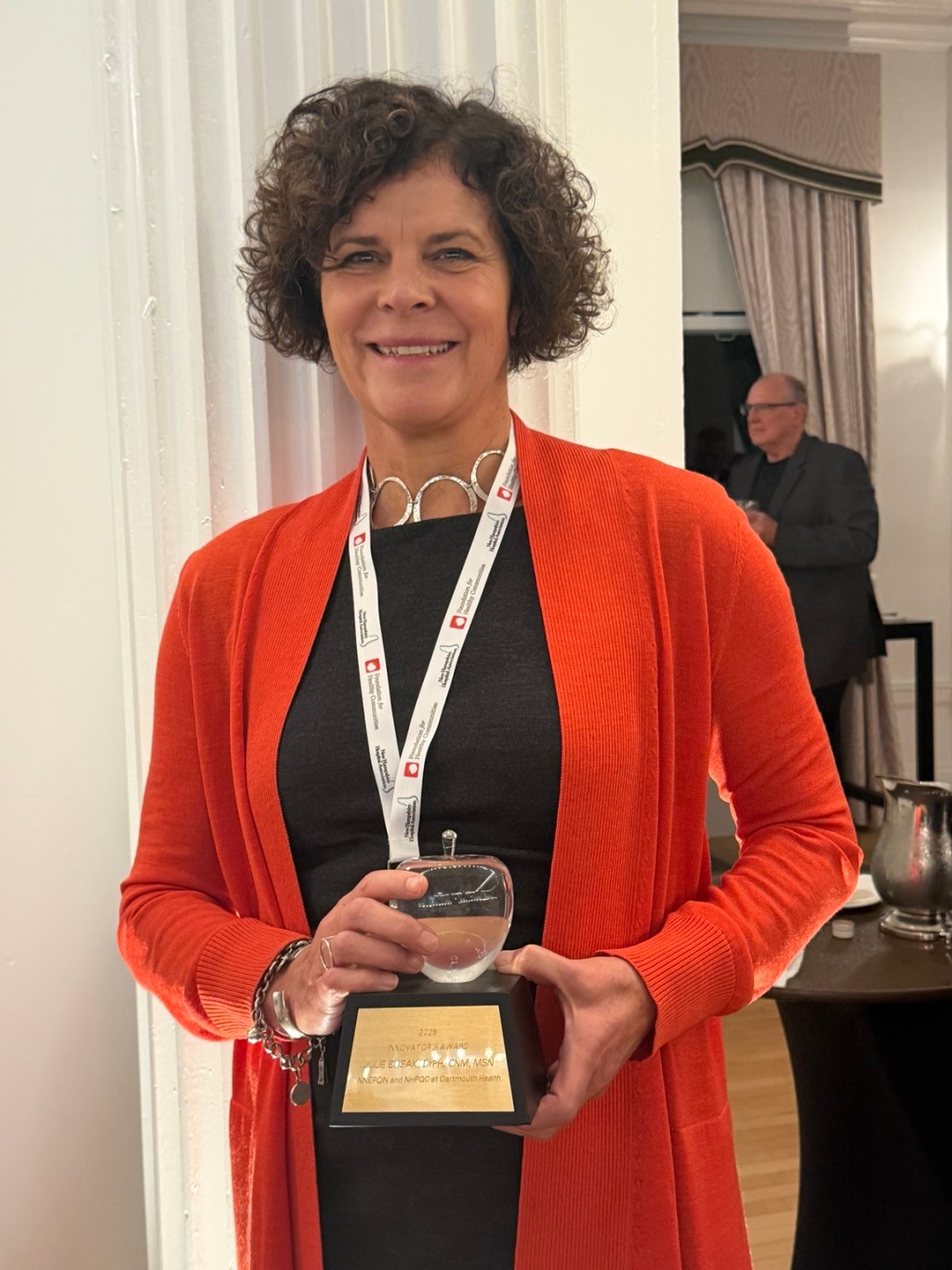 Julie Bosak holding her 2026 Innovator's Award at the New Hampshire Hospital Association meeting.
